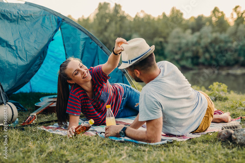 romantic couple on camping together outdoor by the lake