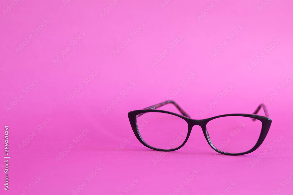 Fashionable stylish glasses on pink background. Optics. Vision. Fashionable stylish glasses on pink background. Optics. Vision.