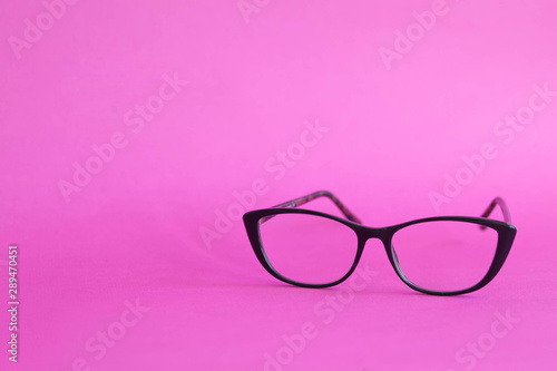 Fashionable stylish glasses on pink background. Optics. Vision.