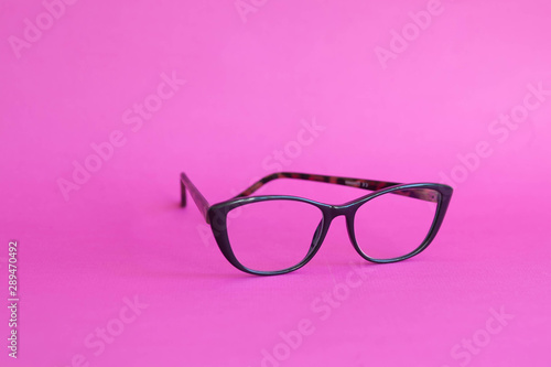 Fashionable stylish glasses on pink background. Optics. Vision.