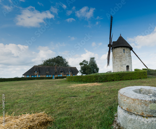 view of the historic windmill Moulin de Pierre and old millstones in Hauville in Normandy