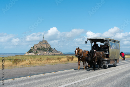 horse and carriage transporting tourists to the famous Mont Saint-Michel in northern France