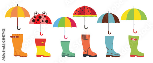 Cute flat umbrellas and rubber boots. Autumn wear concept