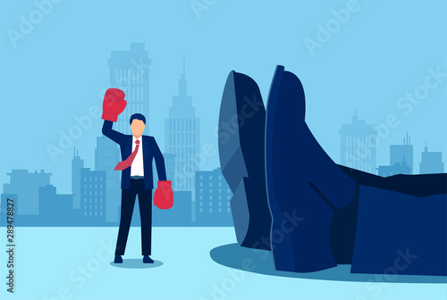 Vector of a small businessman with boxing gloves standing near a giant rival fallen down. photo