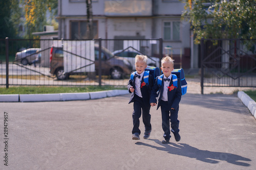 two boys students with briefcases are late for school © Aleksandr