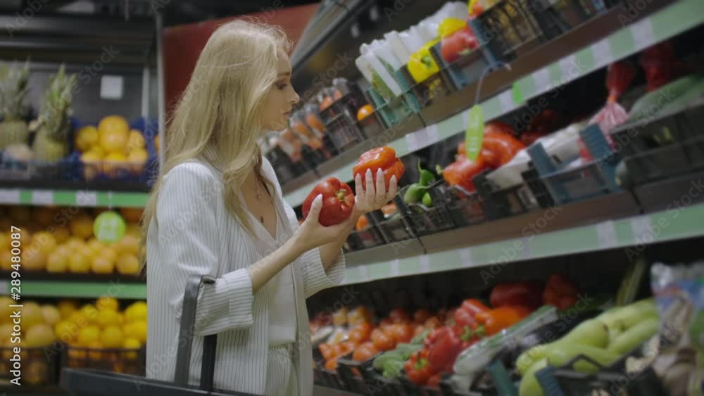 Woman Buying red Pepper in Supermarket. Female Hand Choosing Organic Vegetables in Grocery Store. Zero Waste Shopping and Healthy Lifestyle Concept. Slow motion.