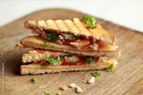 Crispy Grilled Sandwich with cheese, tomato, ketchup, chicken and greens
