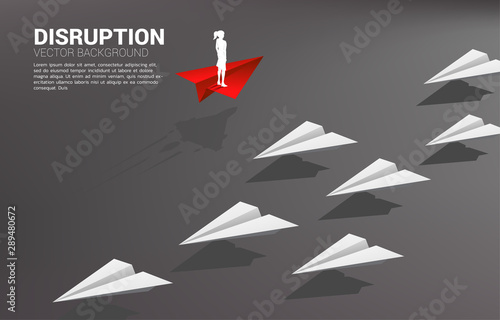 Silhouette of businesswoman standing on red origami paper airplane go different way from group of white. Business Concept of disruption and vision mission.