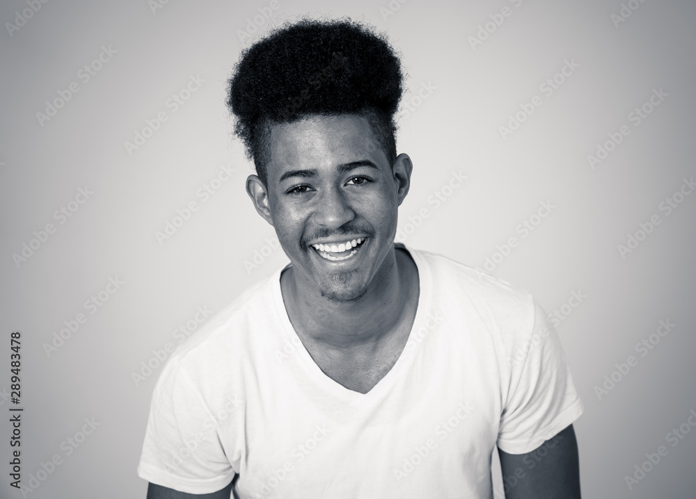 Smiling and laughing attractive african american man in happy face human emotion and expression Smiling and laughing attractive african american man in happy face human emotion and expression