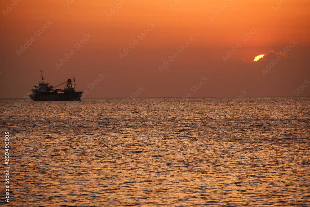 Ship silhouette and sunset