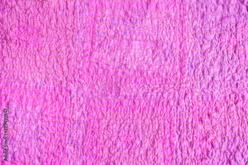 surface of scarf stitched from crushed pink fabric