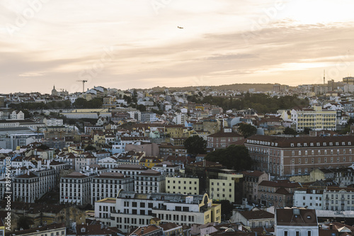 airplane flying over Lisbon at sunset © Raul Mellado