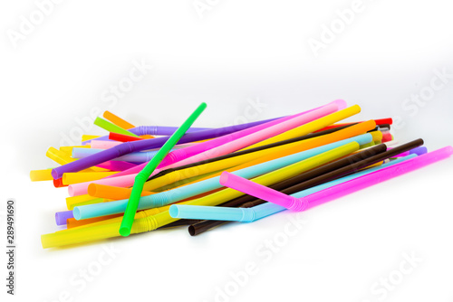 Used plastic straws in a variety of colors, isolated over the white background for copy space.