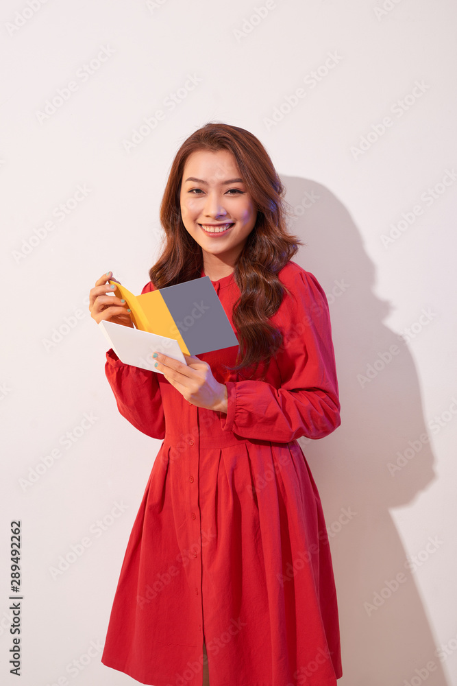 Attractive woman with postcard, isolated on white Attractive woman with postcard, isolated on white