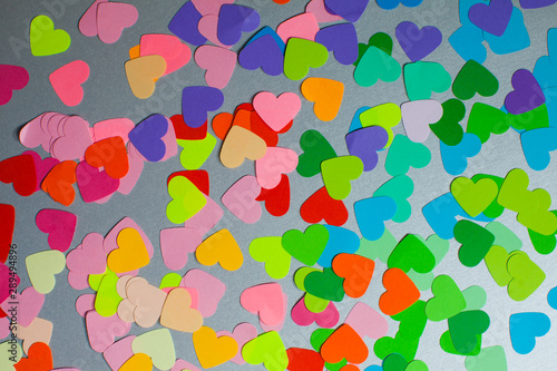Paper rainbow colors hearts as a pattern for design