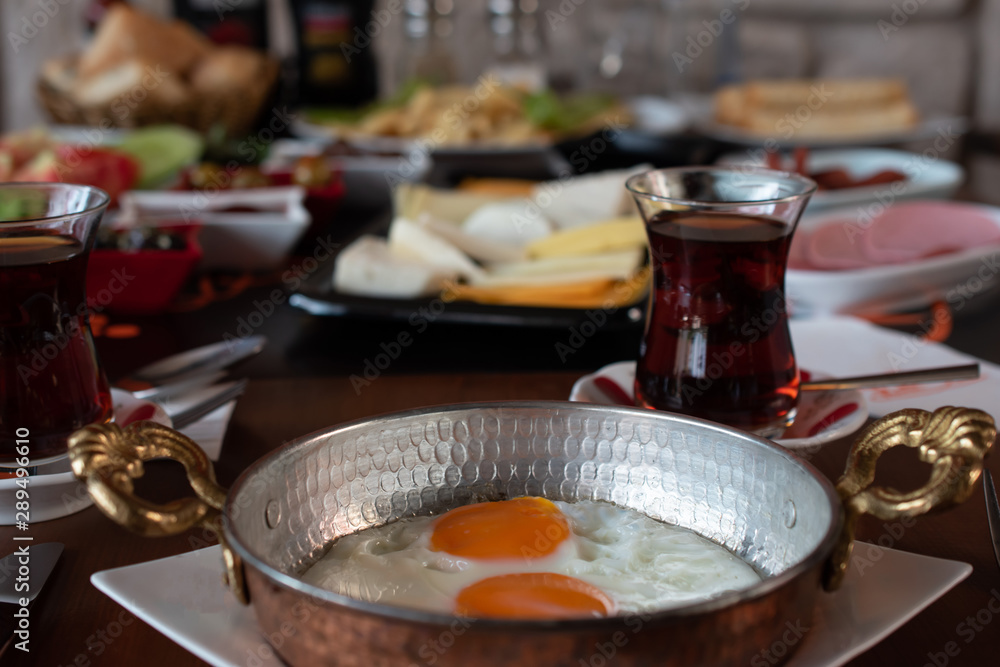 Fried egg with traditional Turkish breakfast and tea