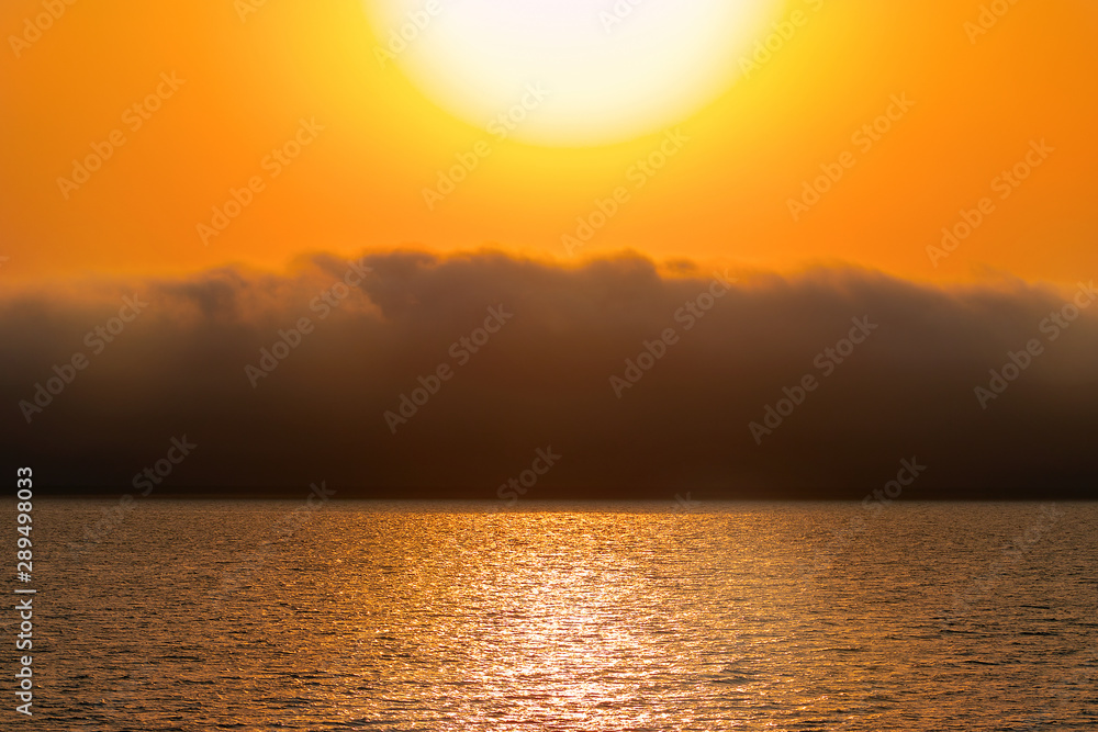 Heavy dramatic clouds and bright sky over the Atlantic Ocean. Beautiful african sunset