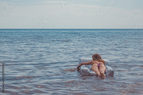 Foto Fascinating a young girl in a swimsuit swimming in the sea