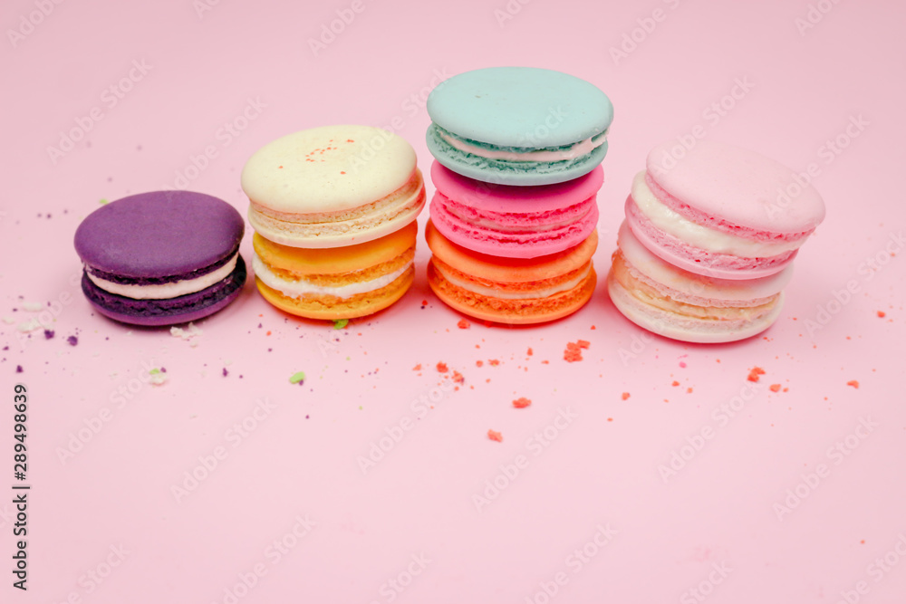 Colorful french macarons (macaroons) cake, delicious sweet dessert on a pink background with copyspace, food background concept. Colorful french macarons (macaroons) cake, delicious sweet dessert on a pink background with copyspace, food background concept.