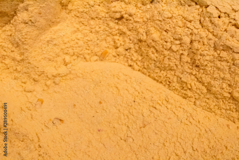 ground corn in a wooden trunk next to a wooden shovel ground corn in a wooden trunk next to a wooden shovel