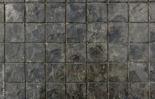 Seamless texture of black stones. Background texture of textured square floor ceramic tiles. Cobblestone background.