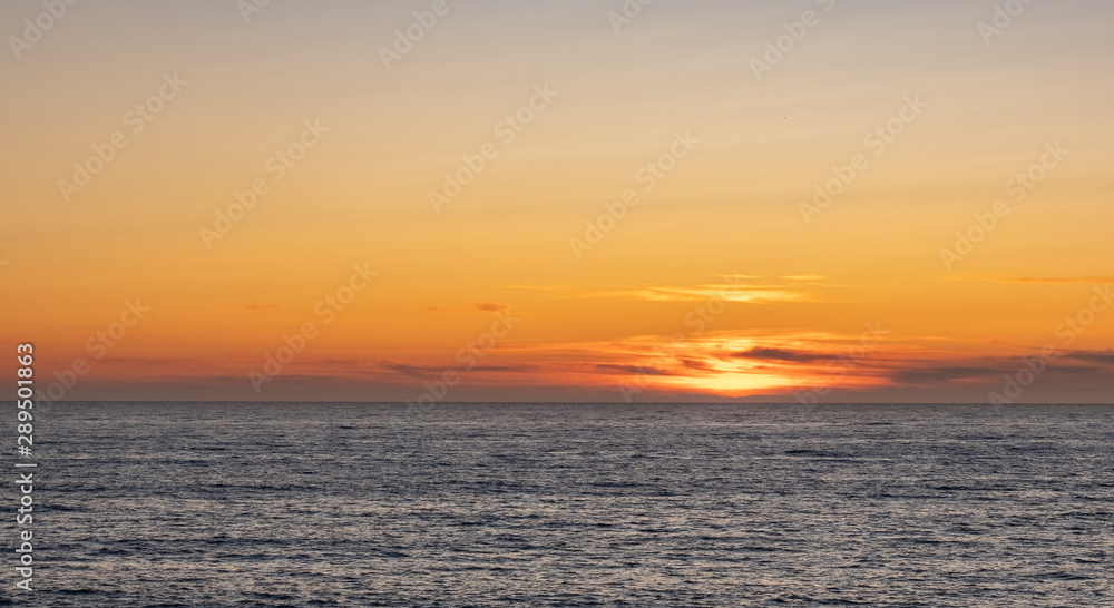 Beautiful orange sky at dusk on the ocean just after sunset