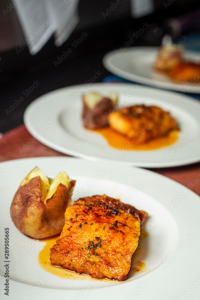 plates with battered cod and roasted potatoes plates with battered cod and roasted potatoes