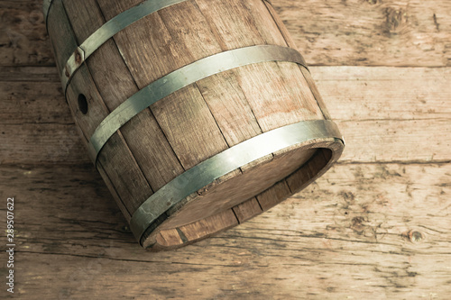 Beautiful wooden barrel and worn old table of wood background. Top view. photo