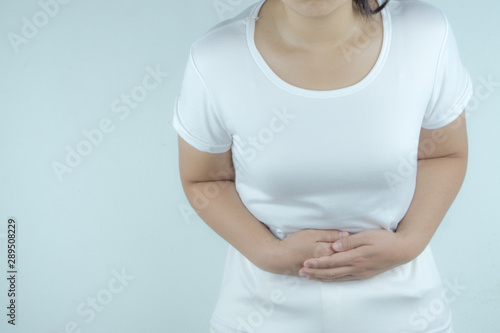 Wallpaper Mural Woman having painful stomachache on white background. Health care and medical concept. Torontodigital.ca