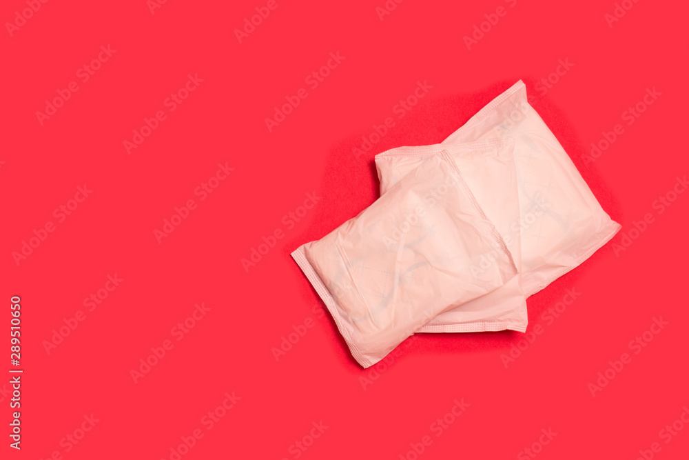 Fototapeta premium sanitary tampons and pads on a red background