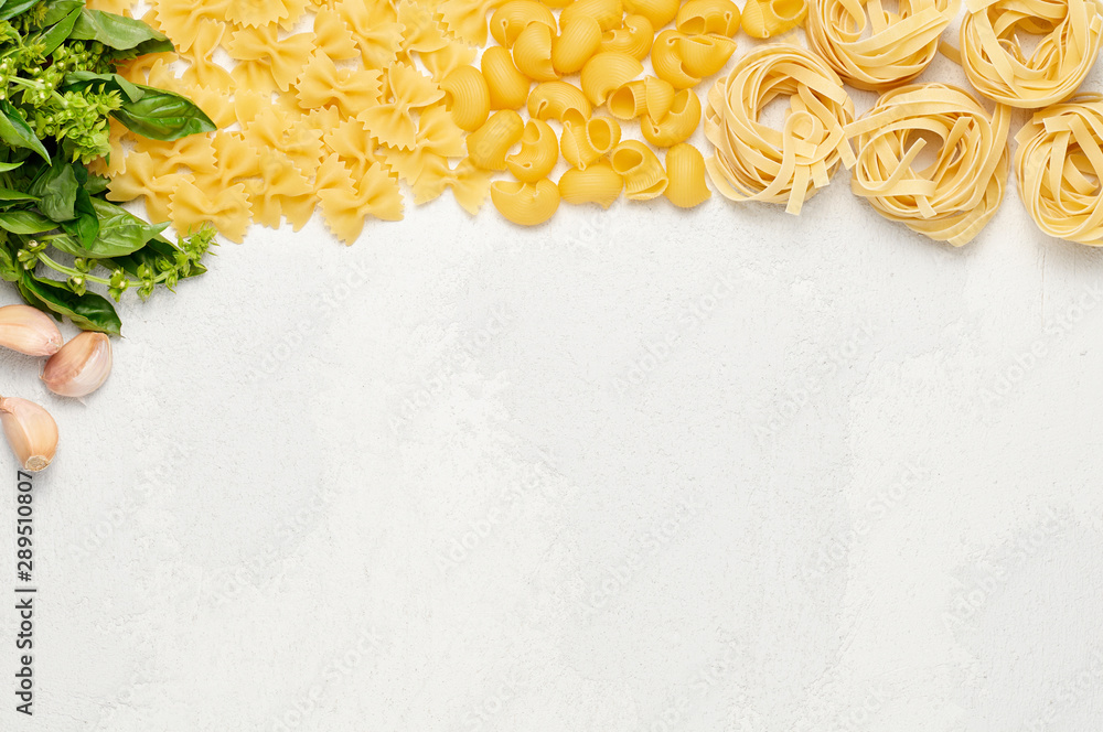 Different types of Italian pasta, fresh basil and garlic