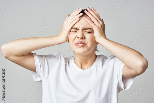 young woman with headache isolated on white