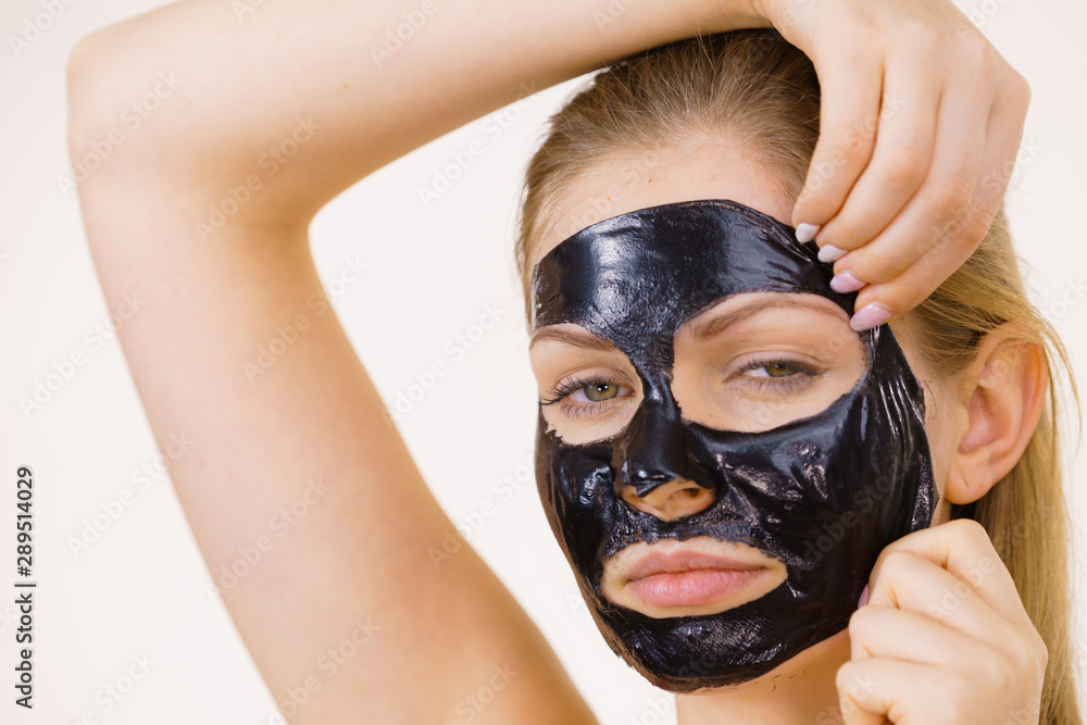 Girl removes black mask from face Girl removes black mask from face