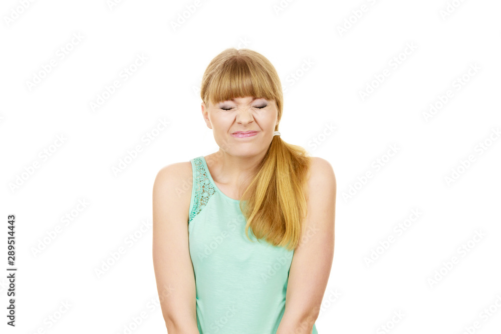 Young woman eyes mouth closed funny face expression Young woman eyes mouth closed funny face expression