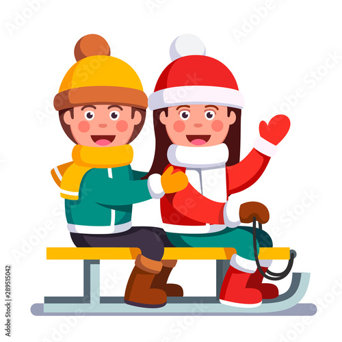 Boy and girl kids sitting on sled in winter