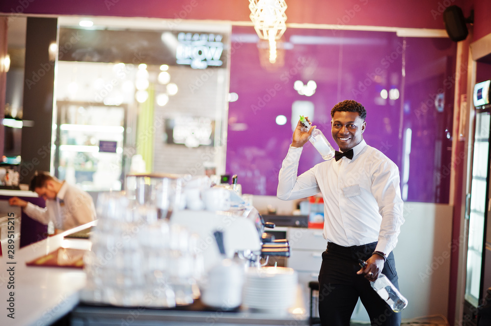African american bartender at bar flair in action, working behind the cocktail bar. Alcoholic beverage preparation. African american bartender at bar flair in action, working behind the cocktail bar. Alcoholic beverage preparation.