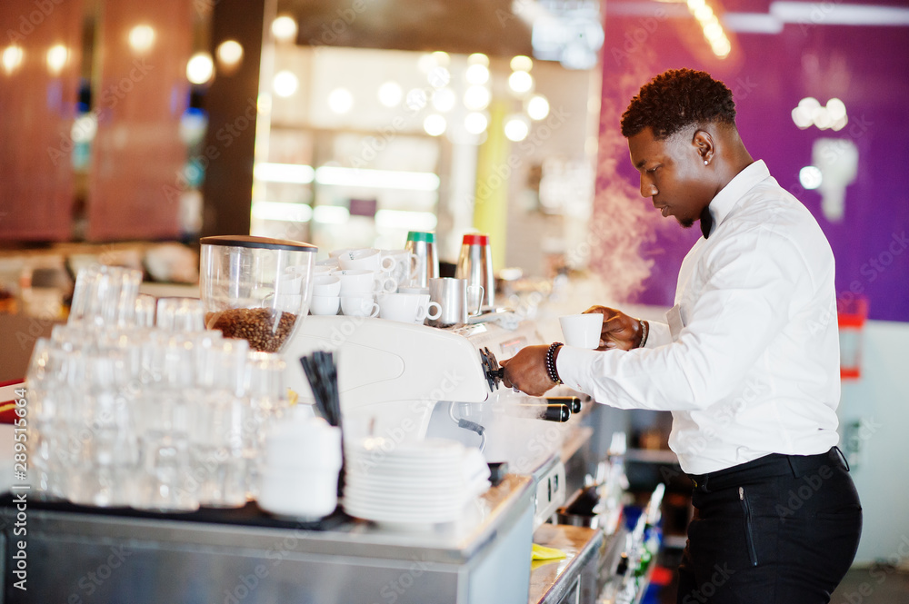 Fototapeta premium African american bartender barista at bar preparing coffee.