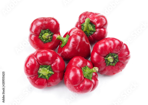 A bunch of ripe red sweet peppers on a white background