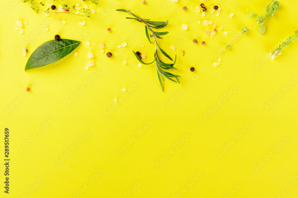 Herbs and spices, shot from the top on a yellow background with a place for text, recipe design template - obrazy, fototapety, plakaty 