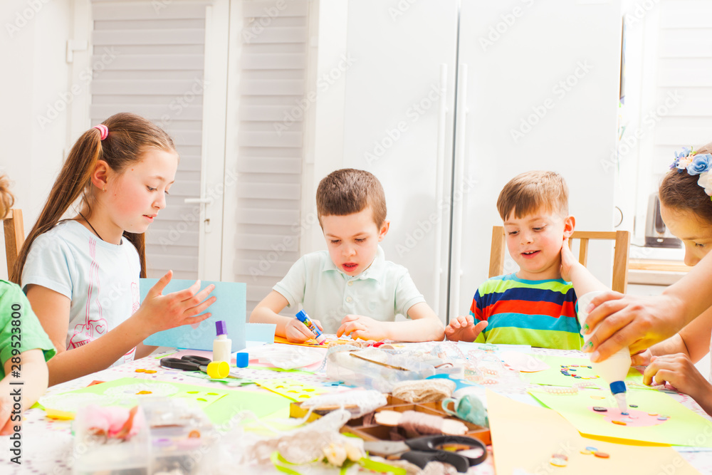 Kids making greeting cards for their moms at the master class Kids making greeting cards for their moms at the master class