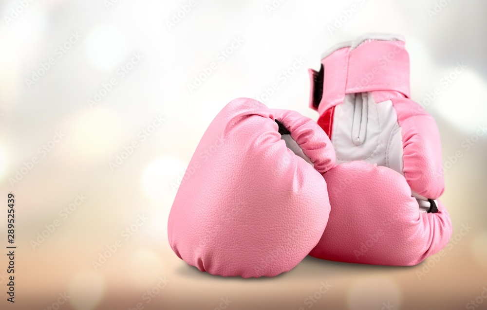Pink boxing gloves on grey background