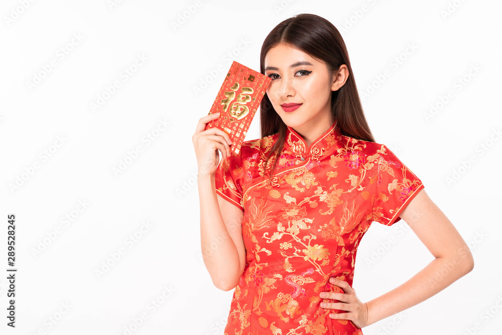 Chinese woman dress in traditional qipao and hold red envelope Chinese woman dress in traditional qipao and hold red envelope