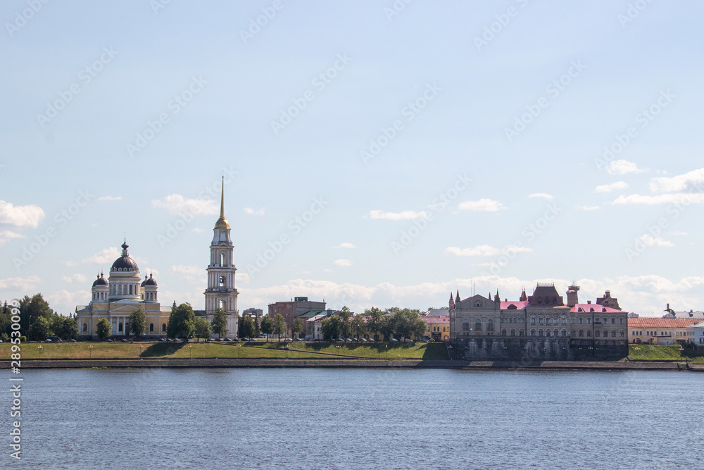 Rybinsk. View of the building of the grain exchange, the Holy Transfiguration Cathedral and the bridge over the Volga river. View from the river