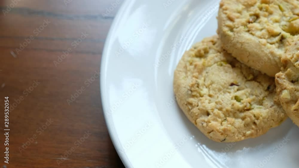 Almond Pistachio Cookies on White Plate tracking shot Almond Pistachio Cookies on White Plate tracking shot