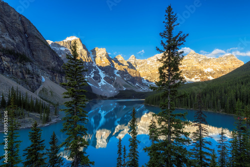 Beautiful sunrise under turquoise waters of the Moraine lake in Canadian Rockies, Banff National Park, Canada