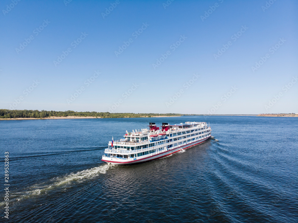 A cruise ship with tourists passes along the Volga downstream towards Astrakhan. Volgograd. Russia A cruise ship with tourists passes along the Volga downstream towards Astrakhan. Volgograd. Russia