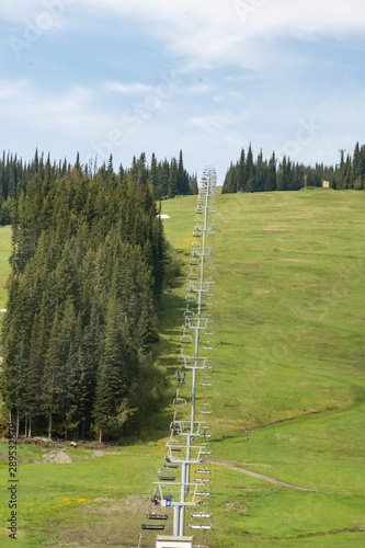 Ski chair lift going up the mountain in Summer