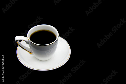 white Cup with black coffee surrounded by roasted coffee beans on a white background. Top view