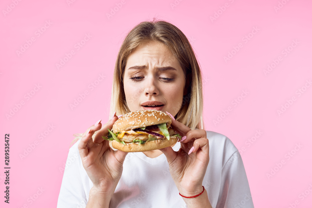 woman with hamburger and french fries isolated on white woman with hamburger and french fries isolated on white