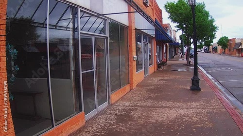 Looking Down Deserted Sidewalk Of Small Town Business District